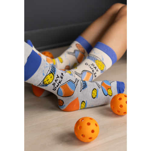 Gray Day Dinker socks featuring colorful pickleball paddles, balls, and nets with a blue cuff and toe design